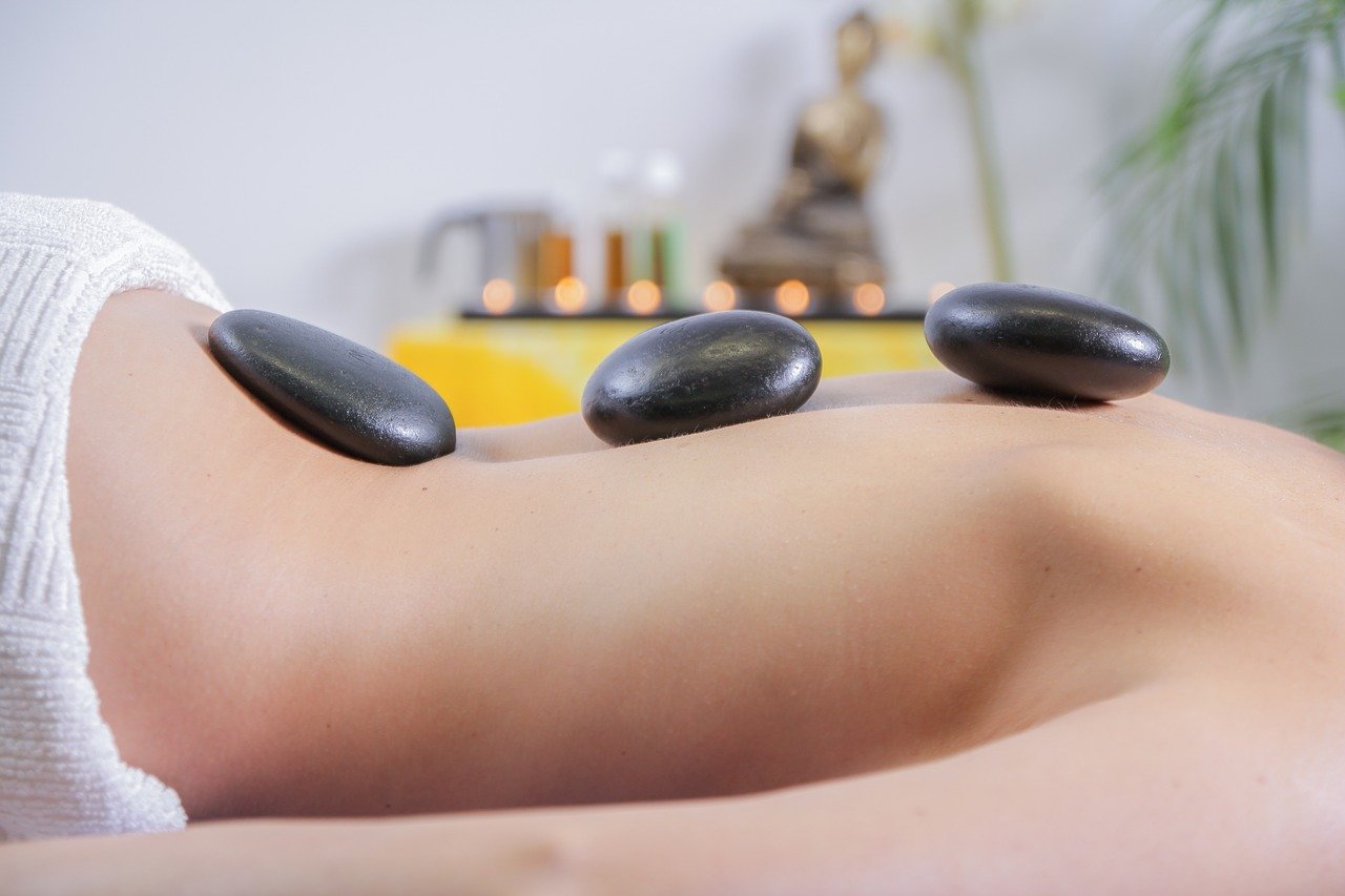 Person receiving a relaxing hot-stone massage therapy session at Estes Park Massage